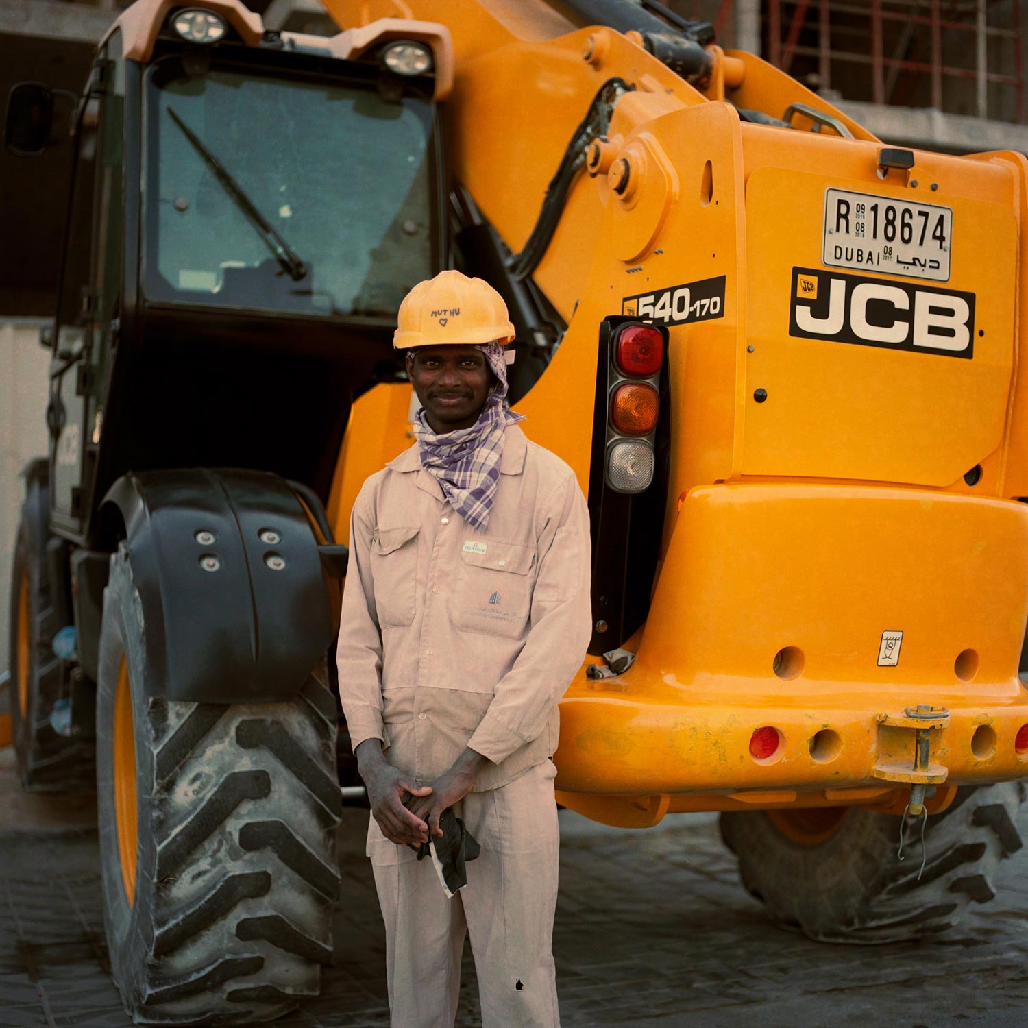 Indian construction workers in Dubai, pose together on site.